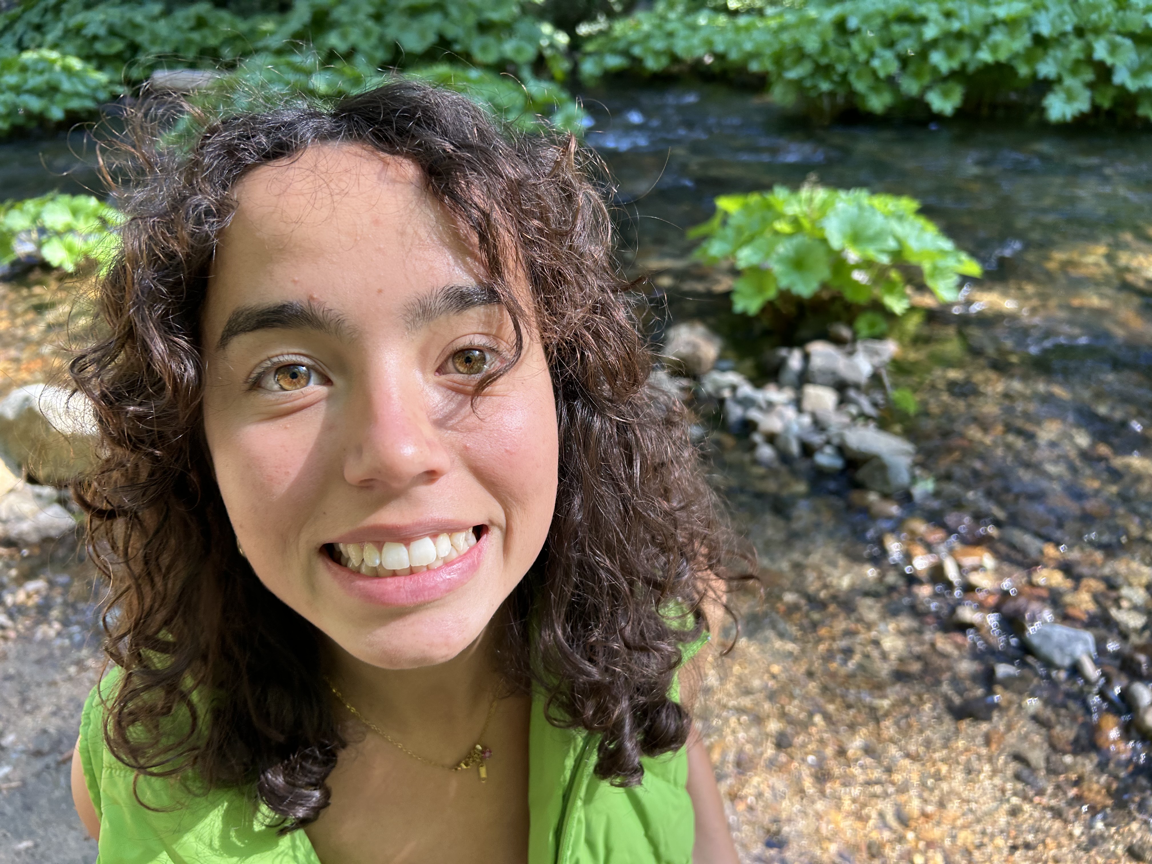 Alison Snyder, yoga instructor, smiling in a natural outdoor setting